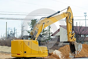 Excavator pouring ground from scoop