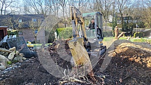 Excavator Power: A Construction Worker Operates a Heavy Machine on a Job Site