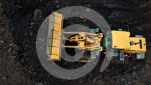 excavator is pushing coal in the pit, aerial view