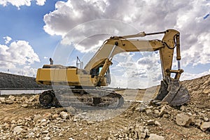 Excavator in a quarry extracting stone