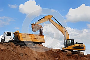 Excavator and rear-end tipper photo