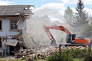 excavator removes debris from demolition old building on construction site