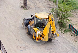 Excavator rides on the road.