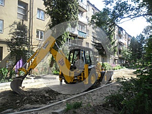 Excavator . road repair of the road in the garden worker escavator