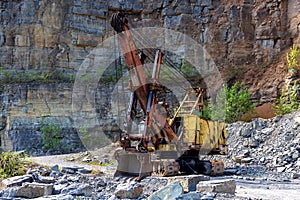 Excavator in a sand quarry. Stone extraction in the canyon