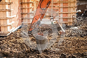 excavator scoop digging earth at construction site