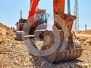 Excavator scoop during earthworks on road construction
