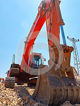 Excavator scoop during earthworks on road construction