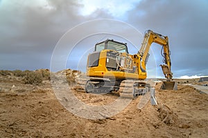 Excavator scooping and leaving tread marks on dirt