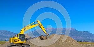Excavator scooping up dirt in Eagle Mountain Utah