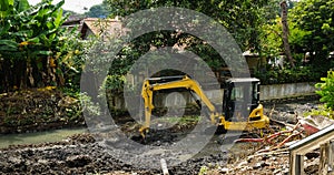 An excavator scrapping mud from river photo taken in Semarang Indonesia