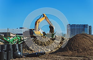 Excavator and screener machine working