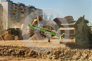 Excavator and screener machine working