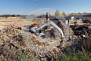 Excavator and shredder designed for pre-processing of materials municipal waste and construction debris roots workes on waste