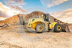 Excavator and stone crusher in a quarry