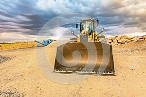 Excavator and stone crusher in a quarry