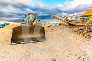 Excavator and stone crusher in a quarry