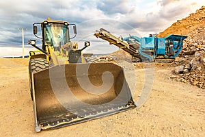 Excavator and stone crusher in a quarry