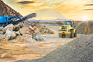 Excavator and stone crusher in a quarry