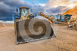 Excavator and stone crusher in a quarry