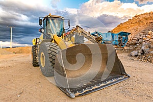 Excavator and stone crusher in a quarry