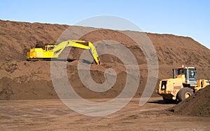 Excavator on Top Soil hill