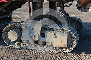 Excavator tracks. Old iron caterpillars of the bulldozer of the tractor on the road. bulldozer caterpillar tracks. Black caterpill