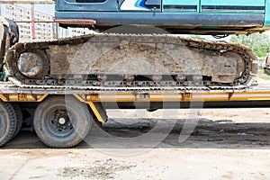 Excavator tracks. Old iron caterpillars of the bulldozer of the tractor on the road. bulldozer caterpillar tracks. Black caterpill