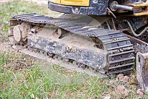 Excavator tracks. Old iron caterpillars of the bulldozer of the tractor on the road. bulldozer caterpillar tracks. Black caterpill