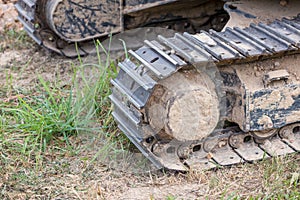 Excavator tracks. Old iron caterpillars of the bulldozer of the tractor on the road. bulldozer caterpillar tracks. Black caterpill