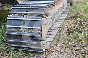 Excavator tracks. Old iron caterpillars of the bulldozer of the tractor on the road. bulldozer caterpillar tracks. Black caterpill