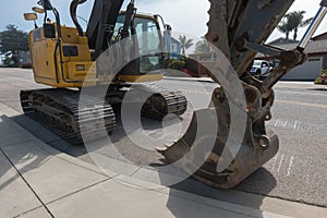 Excavator on tracks parked on the street