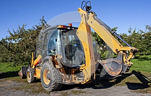 Excavator Tractor in an Apple Orchard
