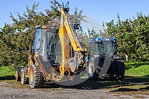 Excavator Tractor in an Apple Orchard