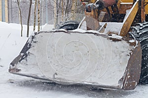 Excavator tractor bucket with snow in winter