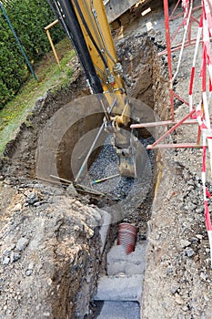 Excavator on trench - constructing canalization