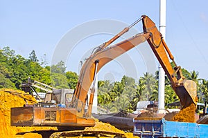 Excavator and truck body at location