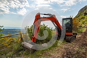 Excavator on the turist`s road based in Konavle region near Dubrovnik.