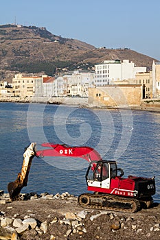 Excavator on the waterfront in Trapani, Sicily
