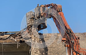 Excavator at work on demolition site