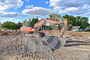 Excavator work at landfill with concrete demolition waste. Salvaging and recycling building and construction materials. Industrial