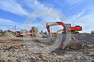 Excavator work at landfill with concrete demolition waste. Salvaging and recycling building and construction materials. Industrial