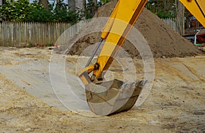 Excavator working bucket moving for foundation in construction site on earthworks