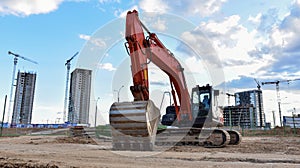 Excavator working at construction site. Backhoe during earthworks. Digging ground for the foundation and for laying sewer pipes