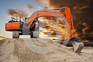 Excavator working on construction site with dramatic clouds on sky
