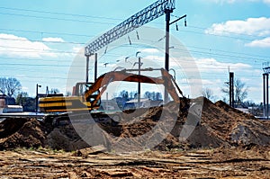 Excavator working on a construction site on railway