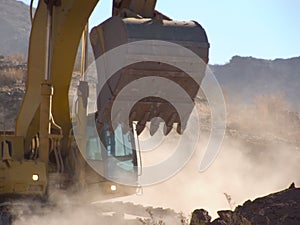 Excavator working the dirt in the desert