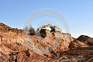 Excavator working on earthmoving at open pit mining. Backhoe digs gravel in quarry. Construction machinery for excavation, loading