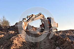 Excavator working on earthmoving at open pit mining. Backhoe digs gravel in quarry. Construction machinery for excavation, loading