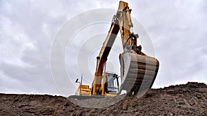 Excavator working on earthmoving at open pit mining. Backhoe digs gravel in quarry. Construction machinery for excavation, loading